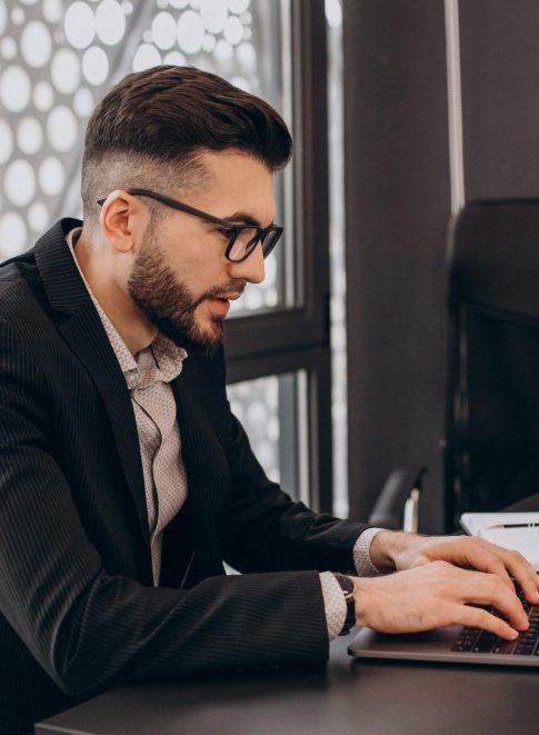Handsome business man working on computer